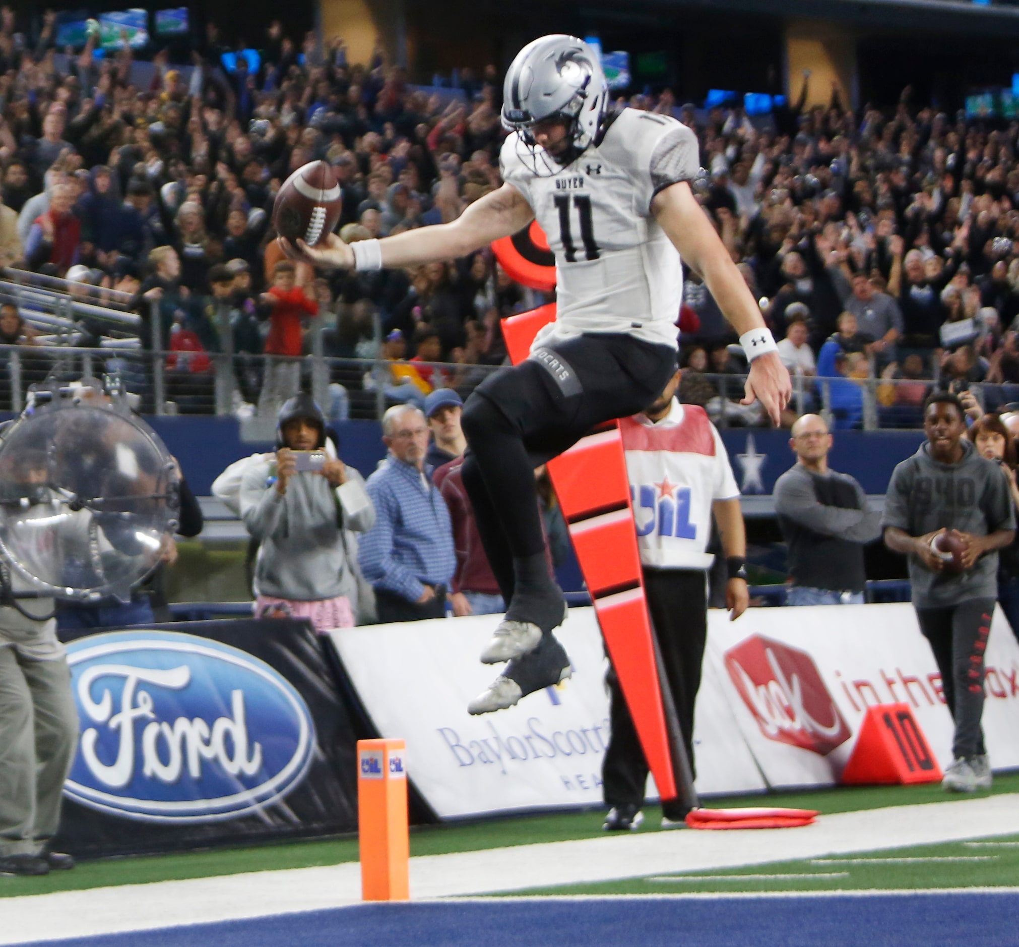 Denton Guyer quarterback Jackson Arnold (11) leaps into the end zone with the Wildcats'...