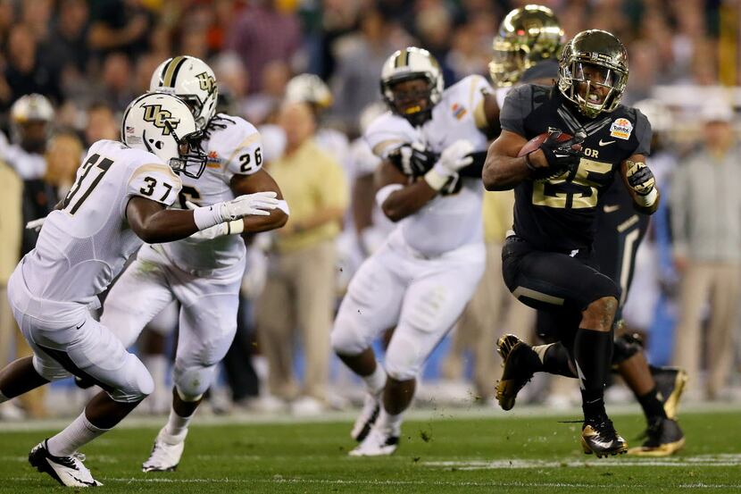 Running back Lache Seastrunk of the Baylor Bears carries the ball against the UCF Knights in...