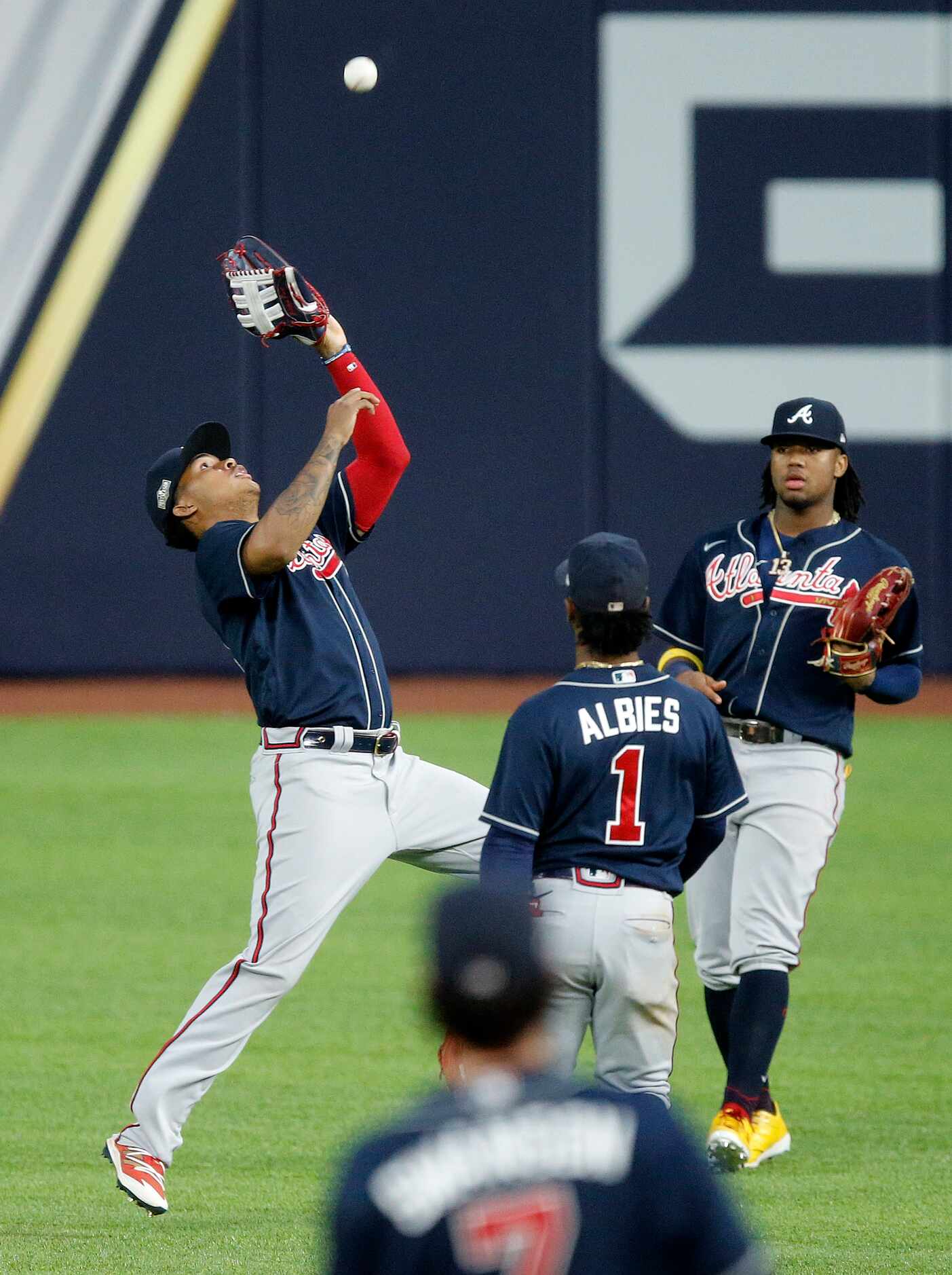 Atlanta Braves center fielder Cristian Pache (14) makes a leaping catch on a ball hit by Los...