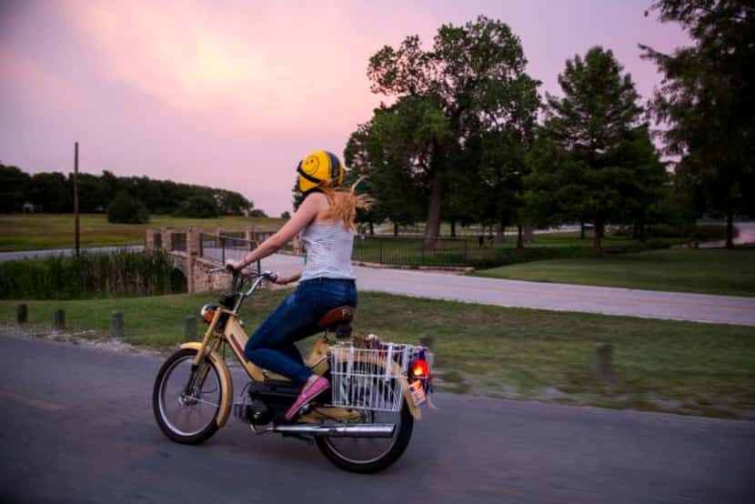 
Katie Arterburn, 29, of Oak Cliff, zooms around a curve on her Puch moped, a birthday...