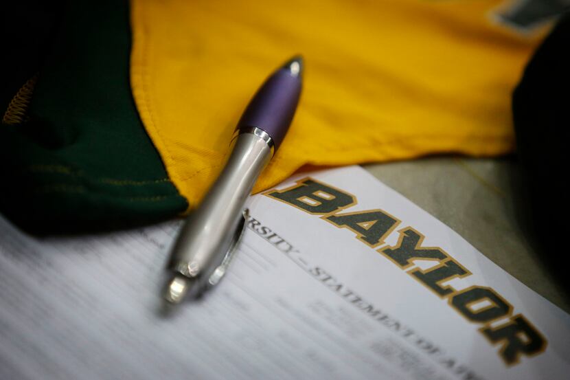 A pen lays on a letter of intent for Breanna Hayden during a DISD National Signing Day...