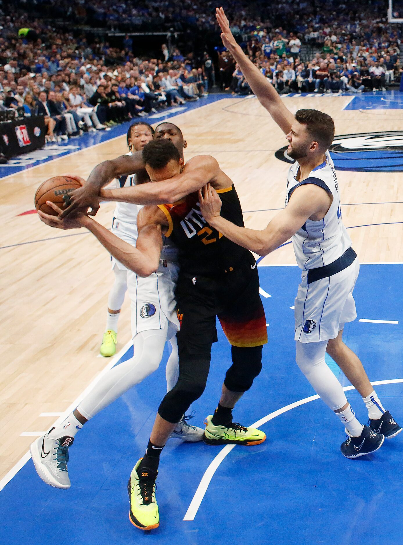 Dallas Mavericks forward Dorian Finney-Smith (behind) wrestles the ball away from Utah Jazz...