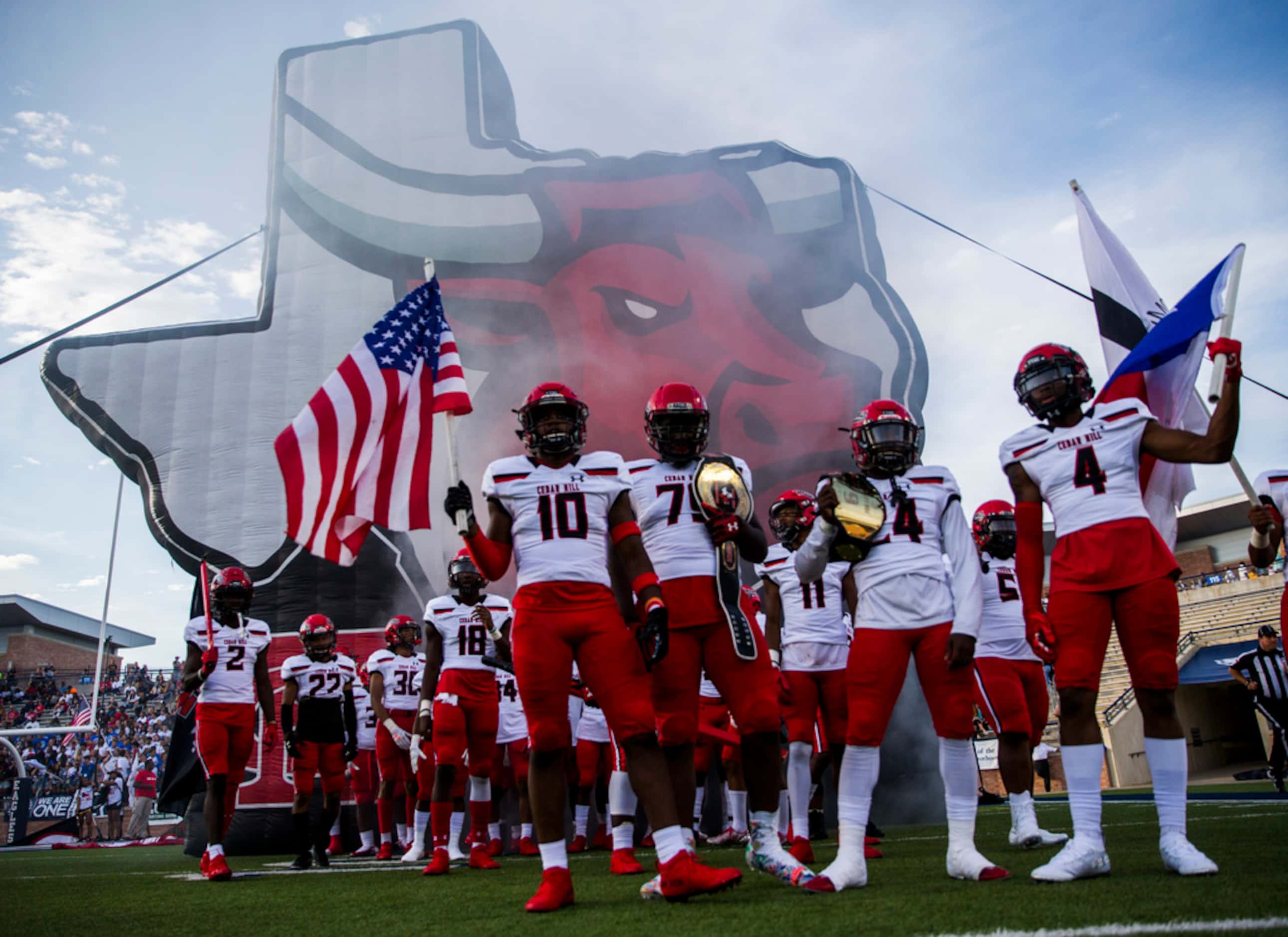 Cedar Hill players prepare to enter the field before a high school football game between...