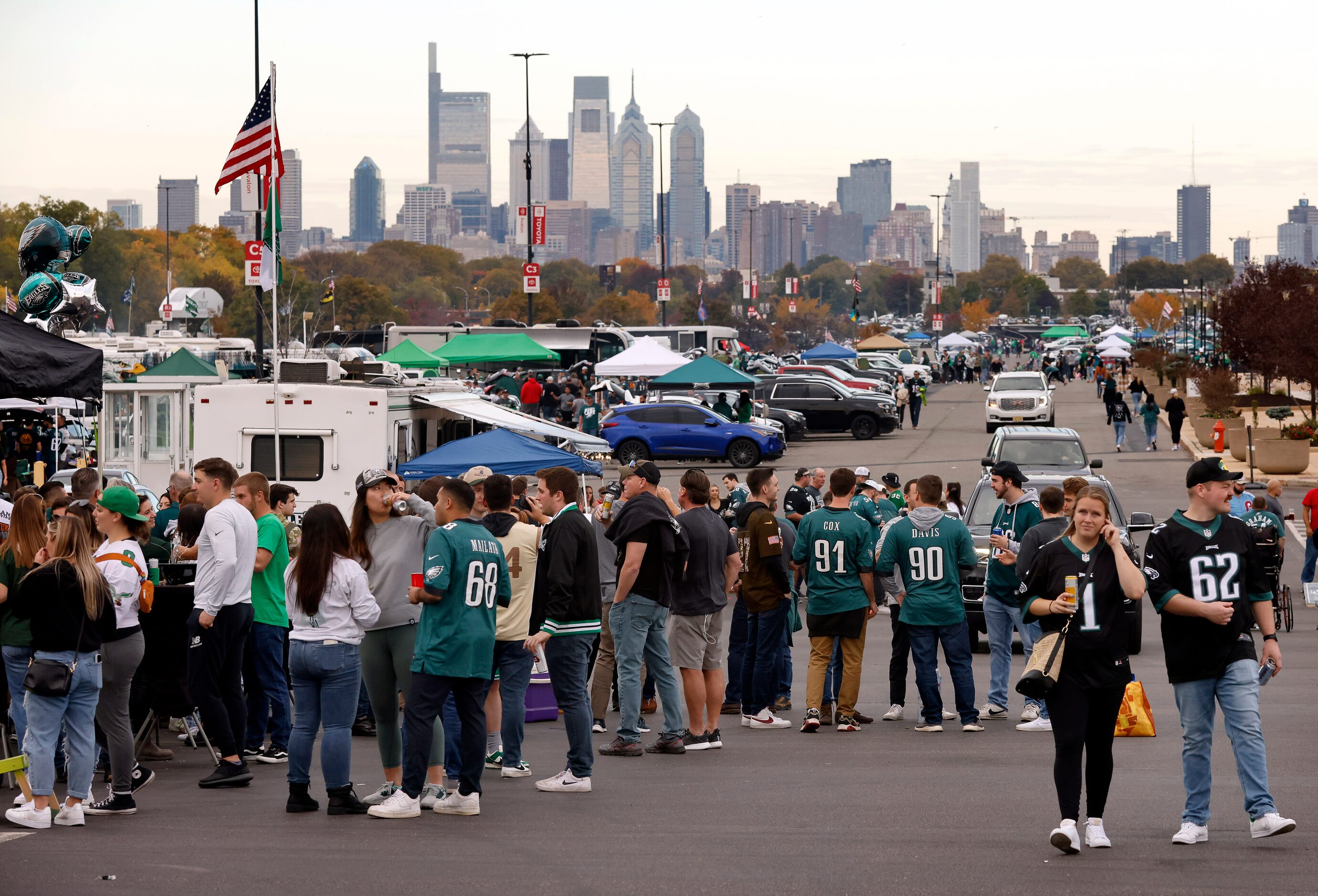 Before the city skyline, Philadelphia Eagles fans tailgate before the Dallas Cowboys game at...