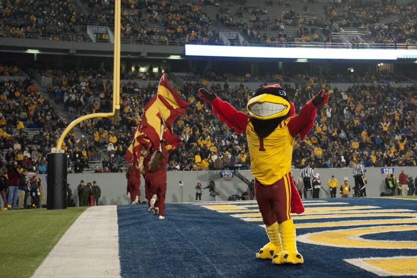 The Iowa State Cyclones cheerleader and mascot celebrate after a touchdown by running back...