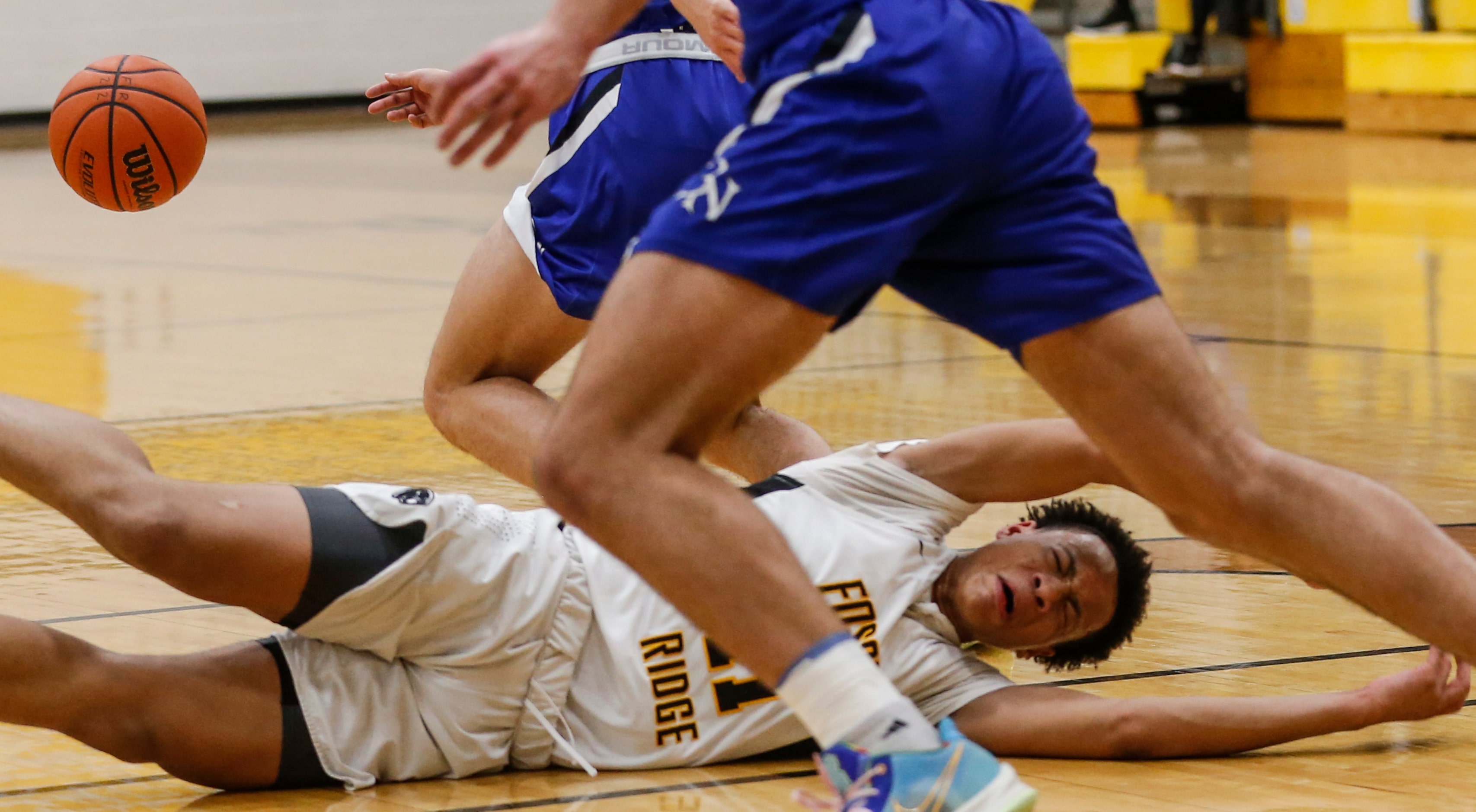 Fossil Ridge High School Kwamir McBean (11) loses possession of the ball after tripping...