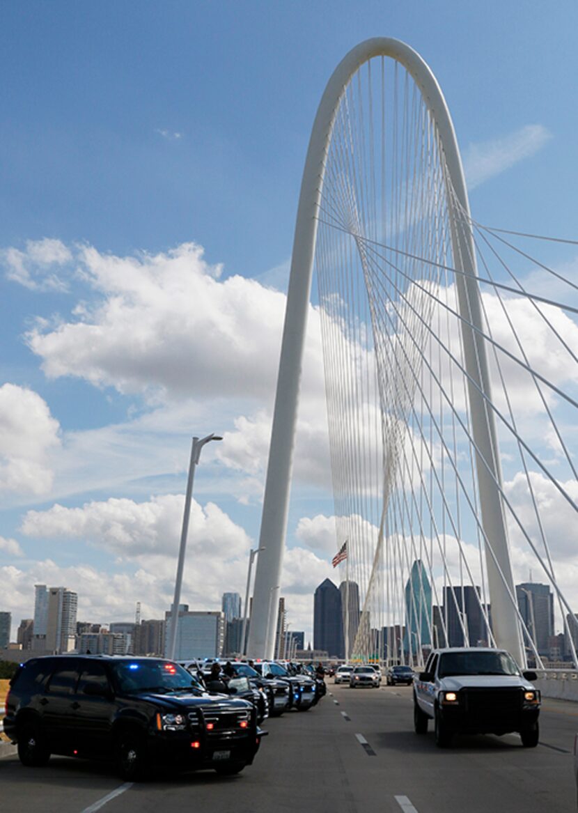  Dallas Sheriff's Department squads lined up about 50 vehicles on the Margaret Hunt Hill...