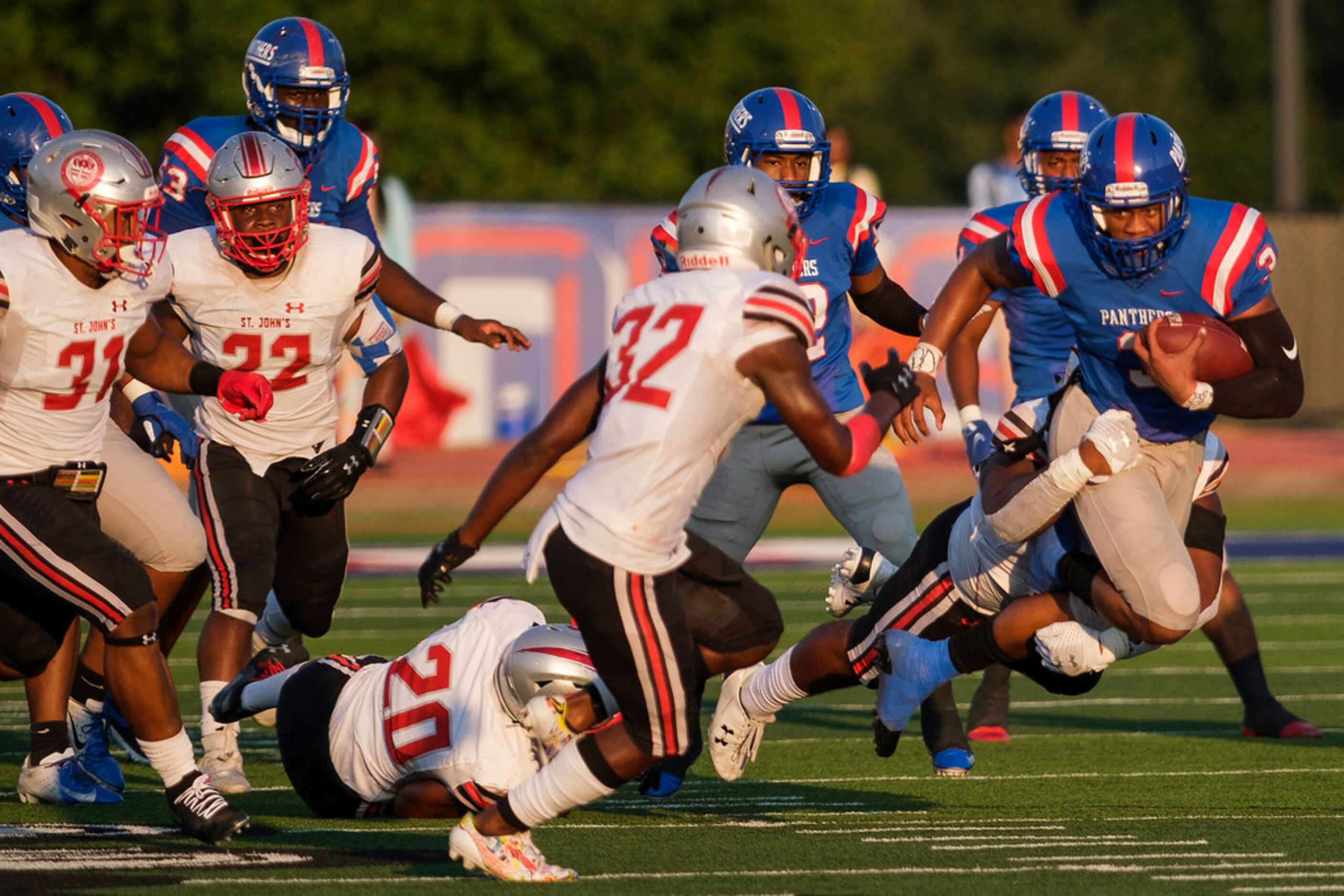 Duncanville quarterback Ja'quinden Jackson (3) is brought down by the St. John's College...