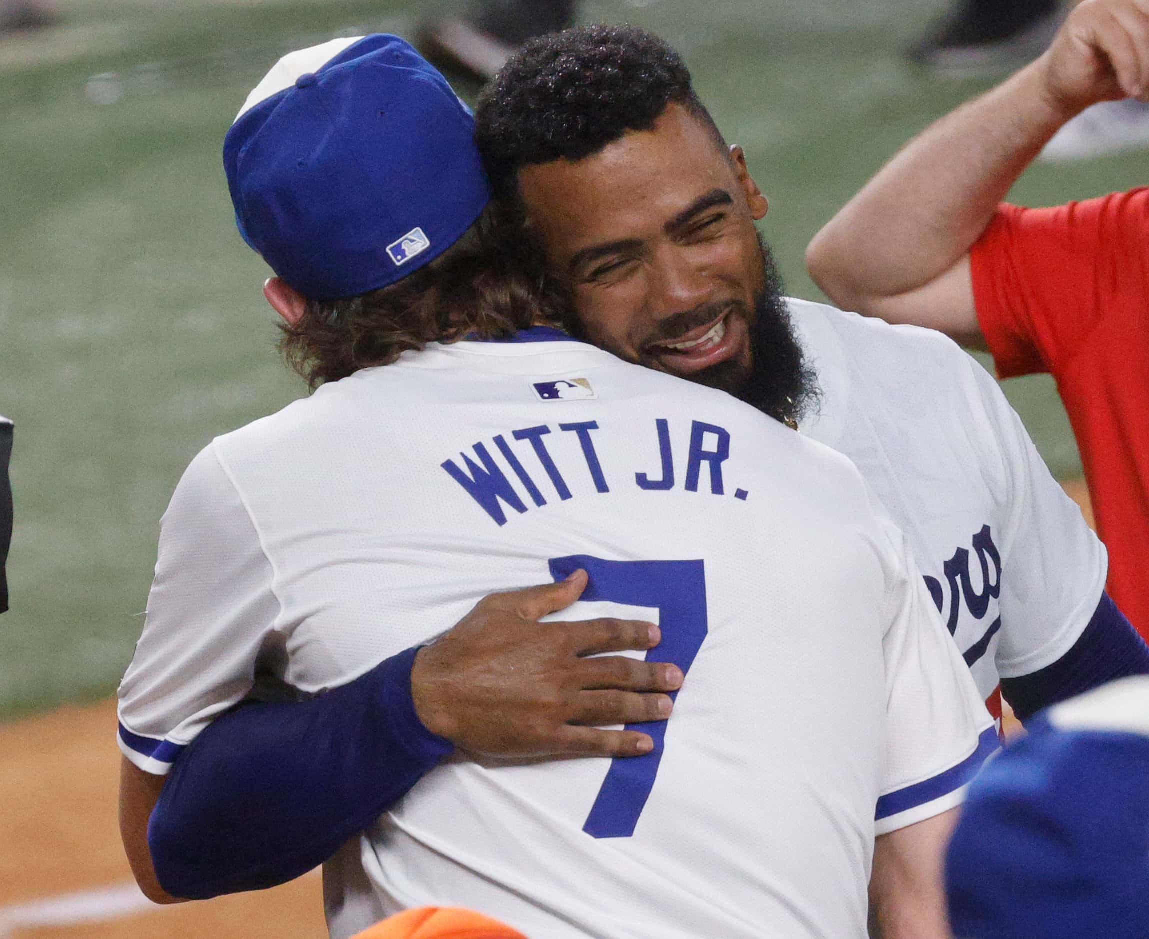 Teoscar Hernandez of Los Angeles Dodgers (37) hugs Bobby Witt Jr. of Kansas City Royals (7)...