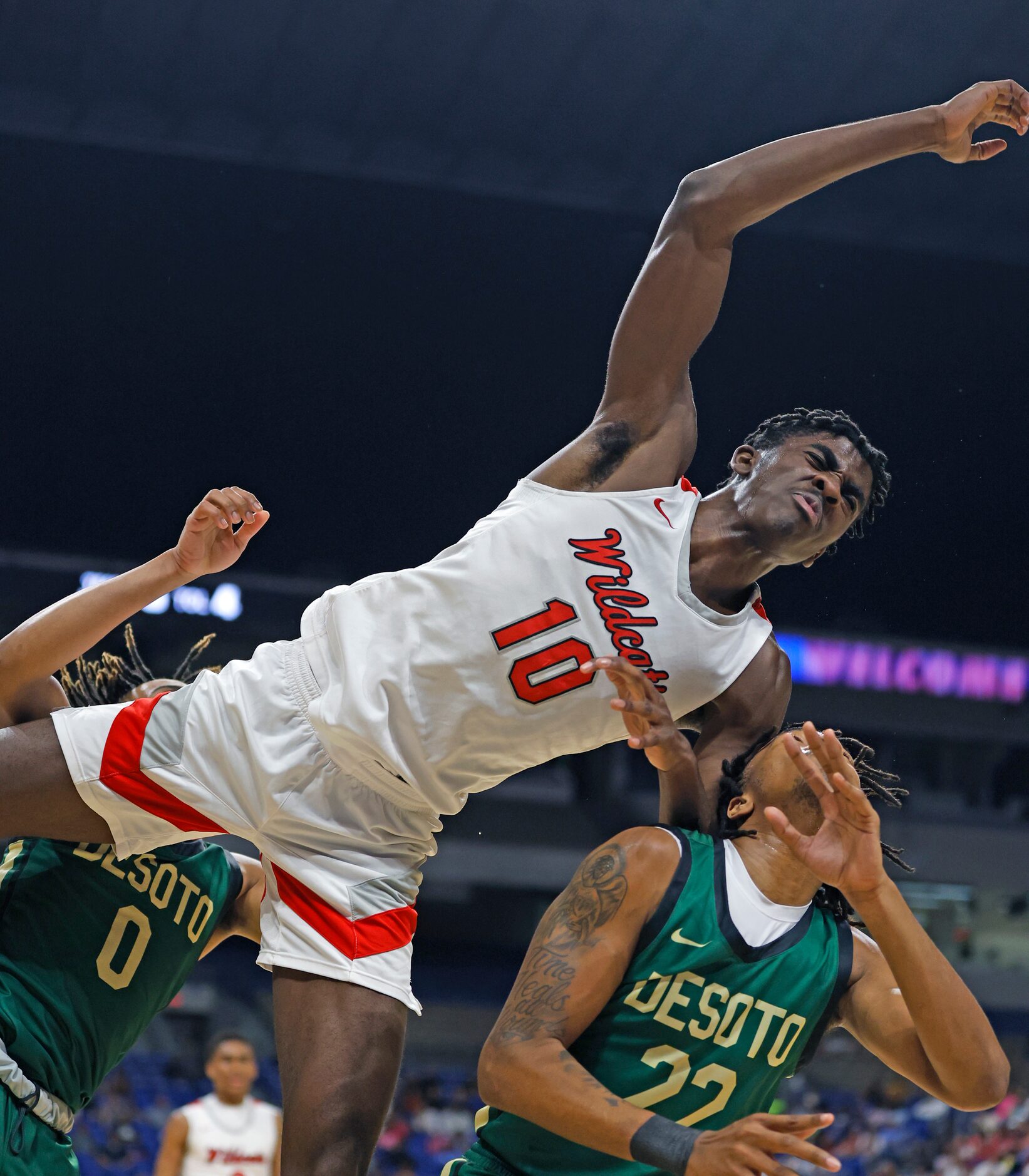 Richardson Lake Highlands Chili Umeh (5) falls over DeSoto Jaxson Davis (22) after a dunk in...