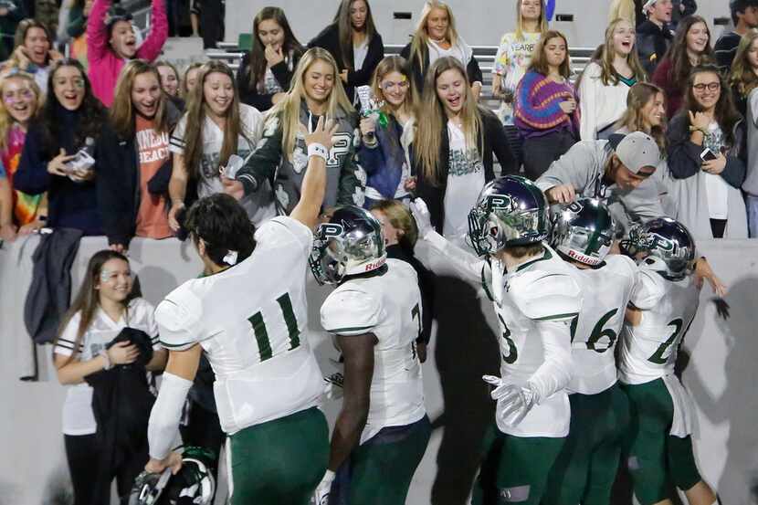 Prosper players celebrate with their fans after their 42-37 win during the Prosper High...