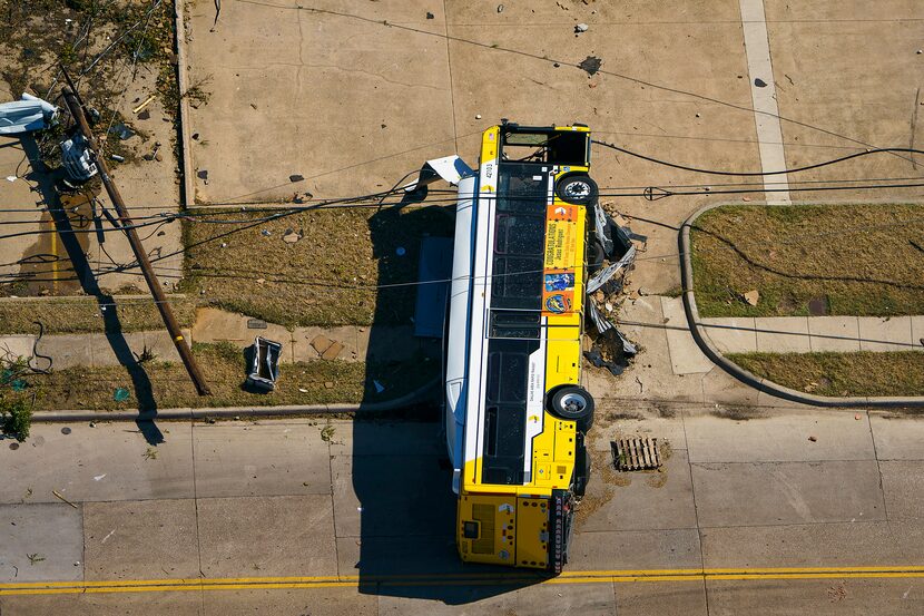 A overturned DART bus is seen near Walnut HIll Lane and Denton Drive on Monday, Oct. 21,...