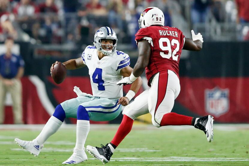 Dallas Cowboys quarterback Dak Prescott (4) attempts to shake Arizona Cardinals defensive...