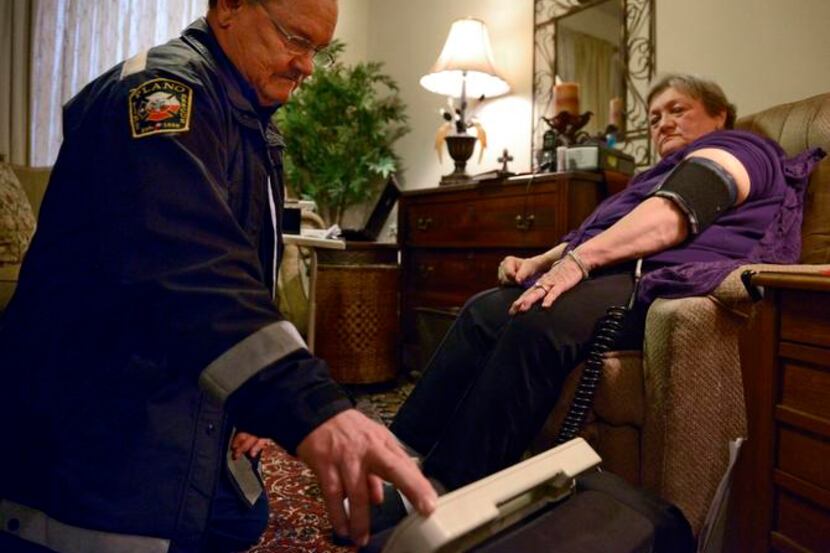 
Jack Sides, EMS captain for Plano Fire-Rescue, took patient Carole Young’s blood pressure...