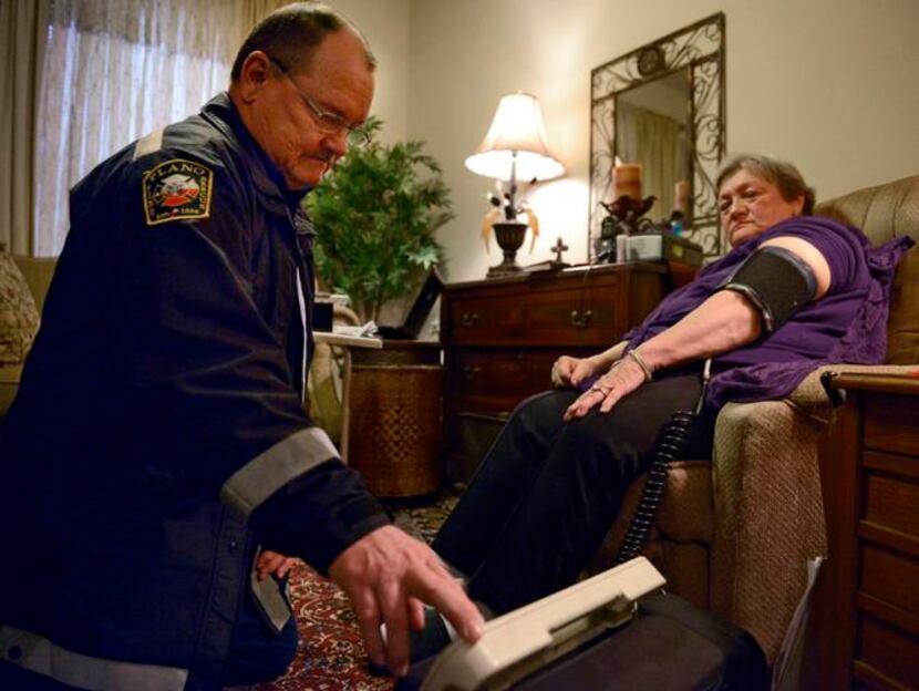 
Jack Sides, EMS captain for Plano Fire-Rescue, took patient Carole Young’s blood pressure...