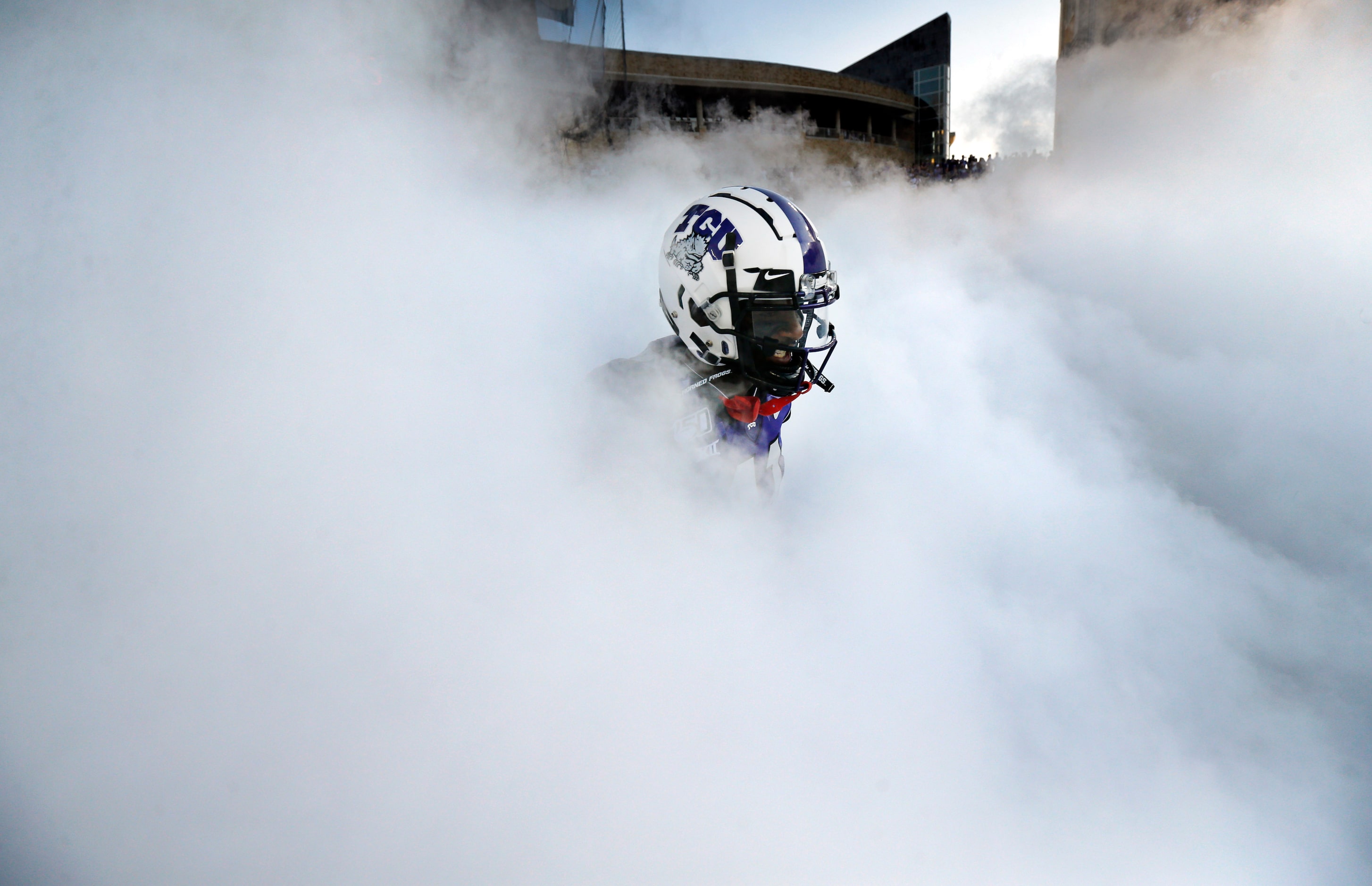 TCU Horned Frogs </bold>wide receiver Dylan Thomas appears in the fog as the team is...