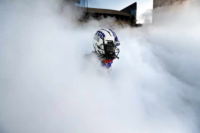 TCU Horned Frogs </bold>wide receiver Dylan Thomas appears in the fog as the team is...