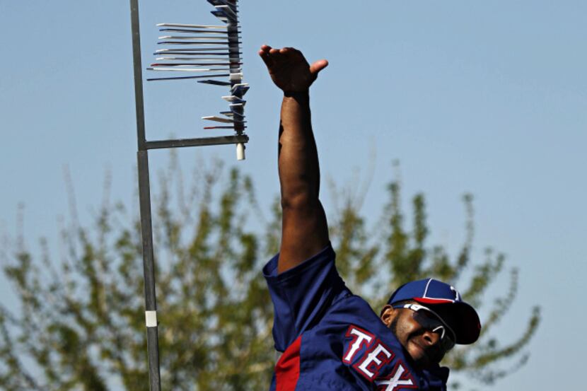 Texas Rangers infielder Elvis Andrus measures his vertical leap during spring training camp...