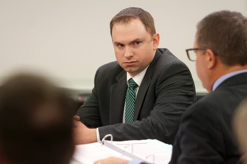 Former Fort Worth police officer Aaron Dean looks towards his attorneys during the second...
