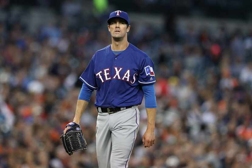 DETROIT, MI - MAY 6: Cole Hamels #35 of the Texas Rangers walks of the mound at the end of...