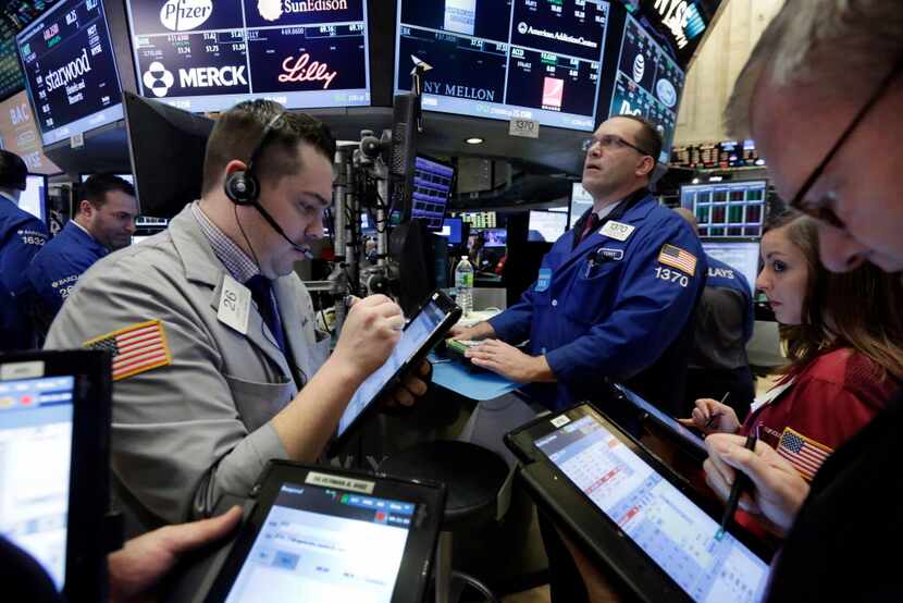 Traders gather at the post of Anthony Matesic, background right, on the floor of the New...