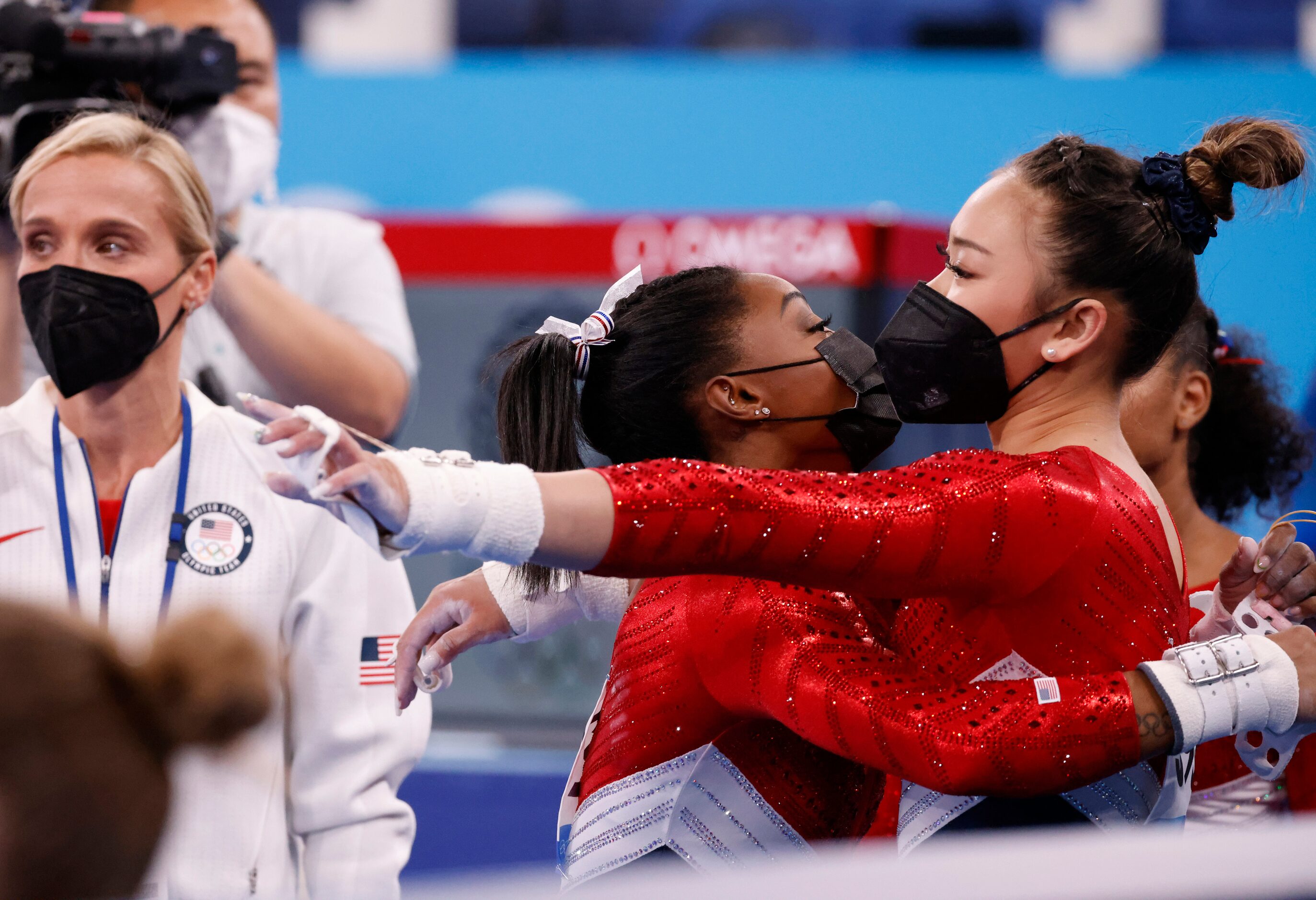 USA’s Simone Biles hugs Sunisa Lee after returning to the field of play shortly after...