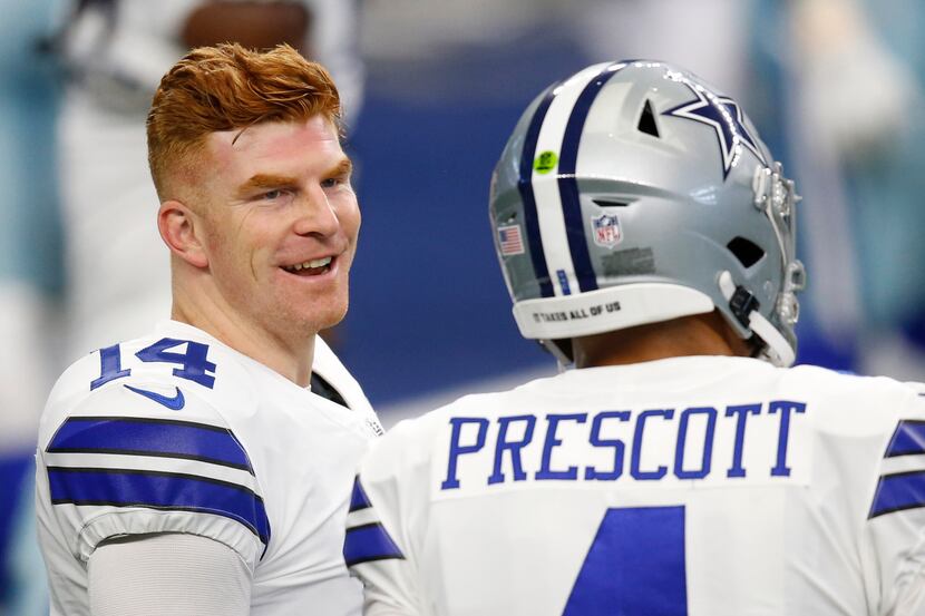 Dallas Cowboys quarterback Andy Dalton (14) talks with Dallas Cowboys quarterback Dak...