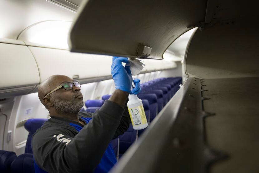 A Southwest Airlines employee cleans a plane as the airline steps up hygiene measures to...