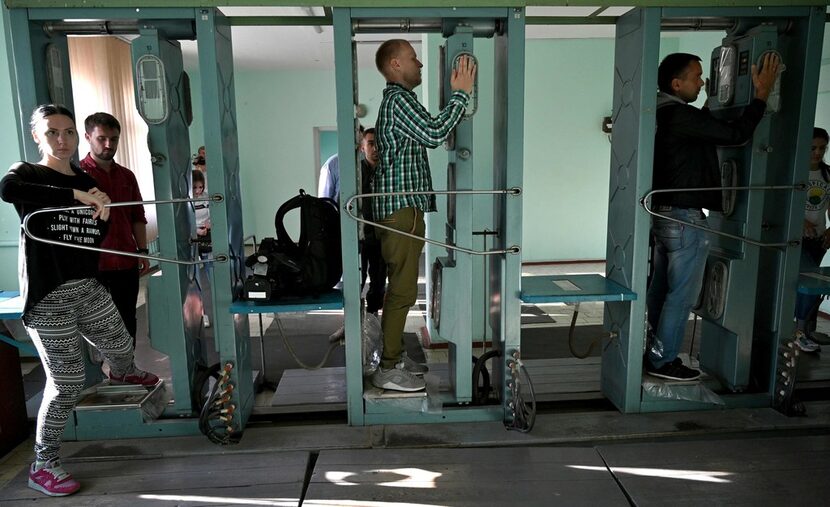 People pass through a radiation-measuring device during a tour of the Chernobyl Exclusion Zone.