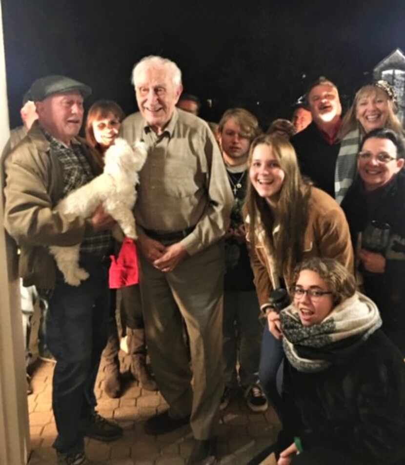 Barney Baker and his dog, SheShe, greeted Christmas carolers on a recent evening in his...