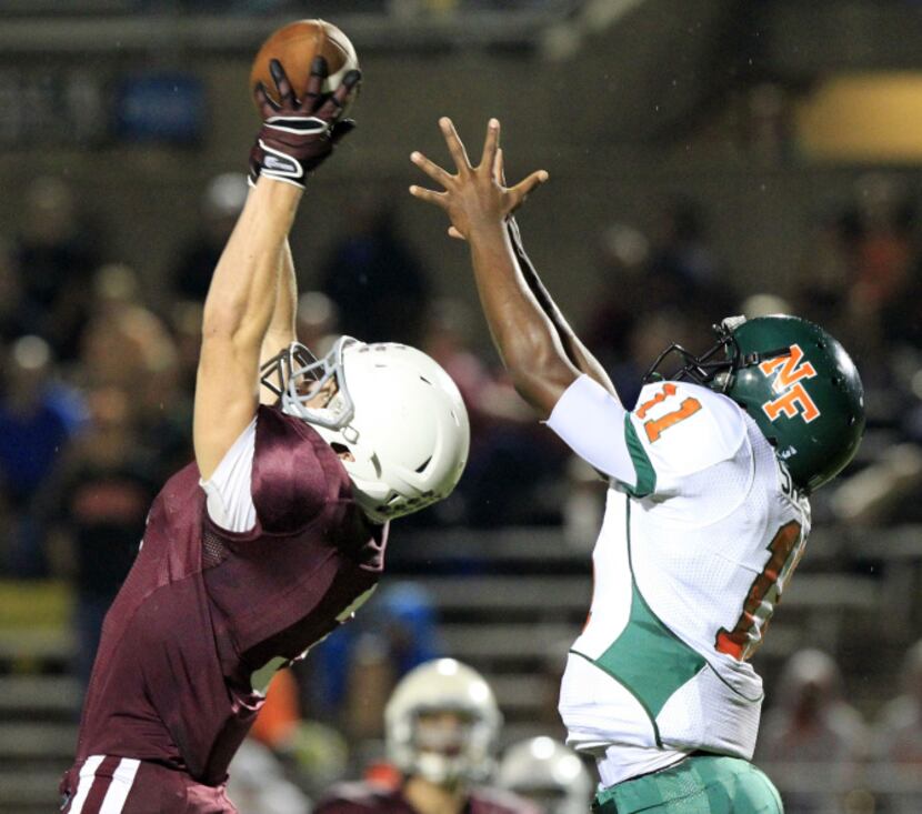 Plano Senior High's Cody Farhat (3) intercepts a pass intended for Garland Naaman Forest...