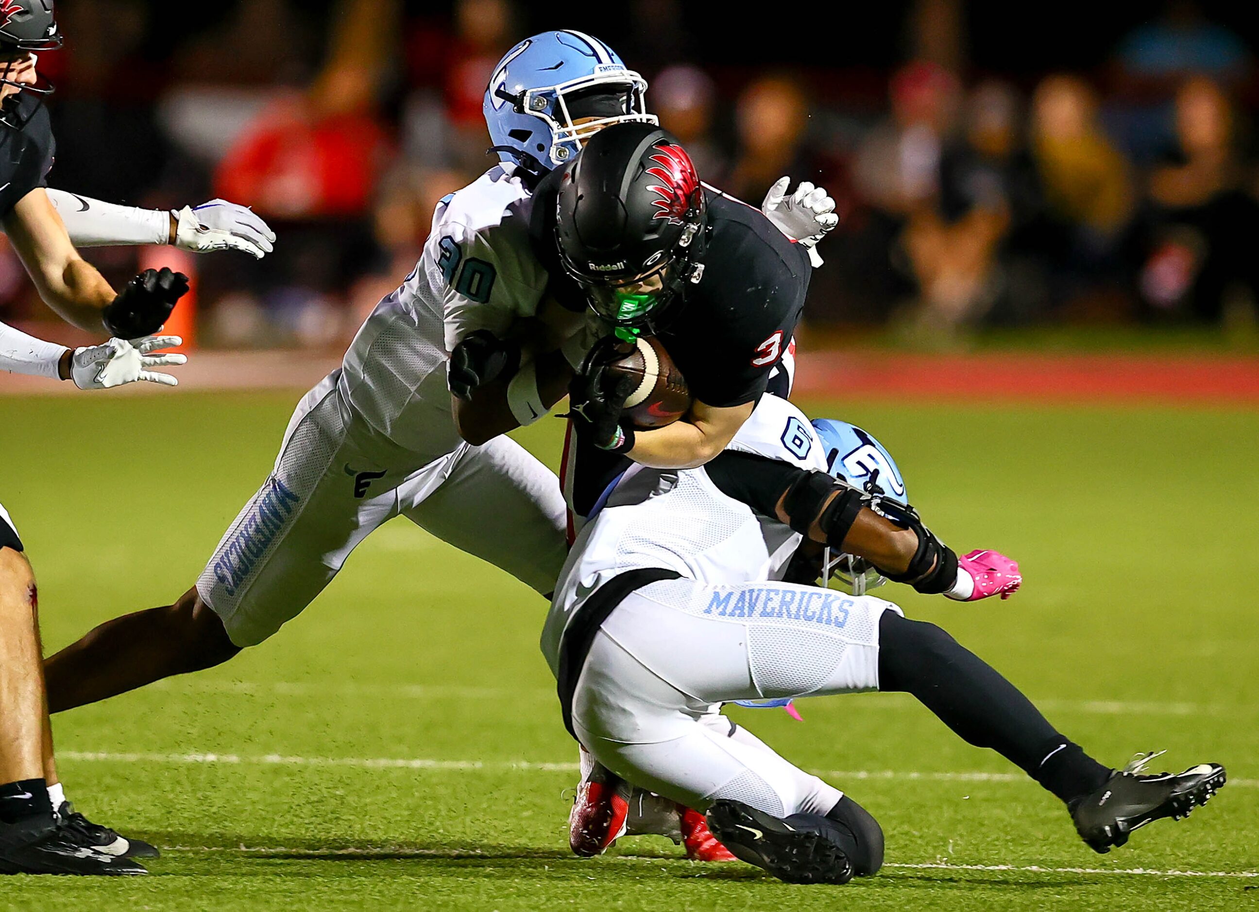 Argyle running back Jake Krekeler (3) gets stopped for a short gain by Frisco Emerson...