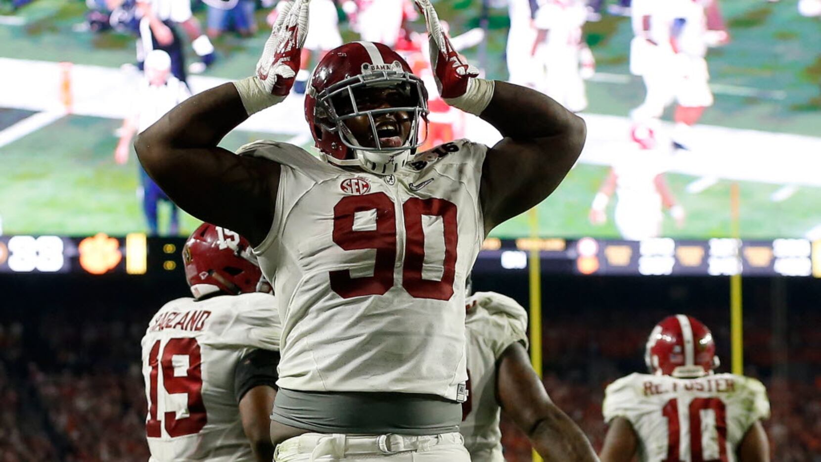 Jarran Reed #90 of the Alabama Crimson Tide celebrates a play against the Clemson Tigers...