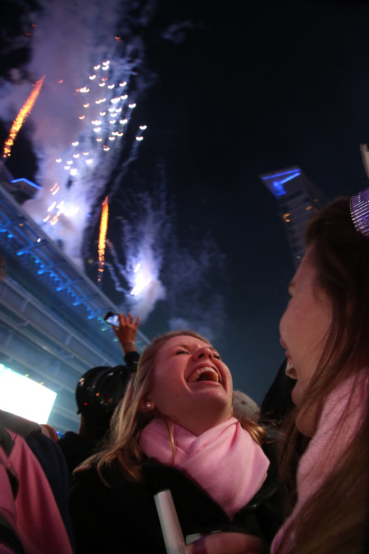 Sarah Cooper (left) and Elizabeth Cooper laugh as they watch fireworks at the Big D New...