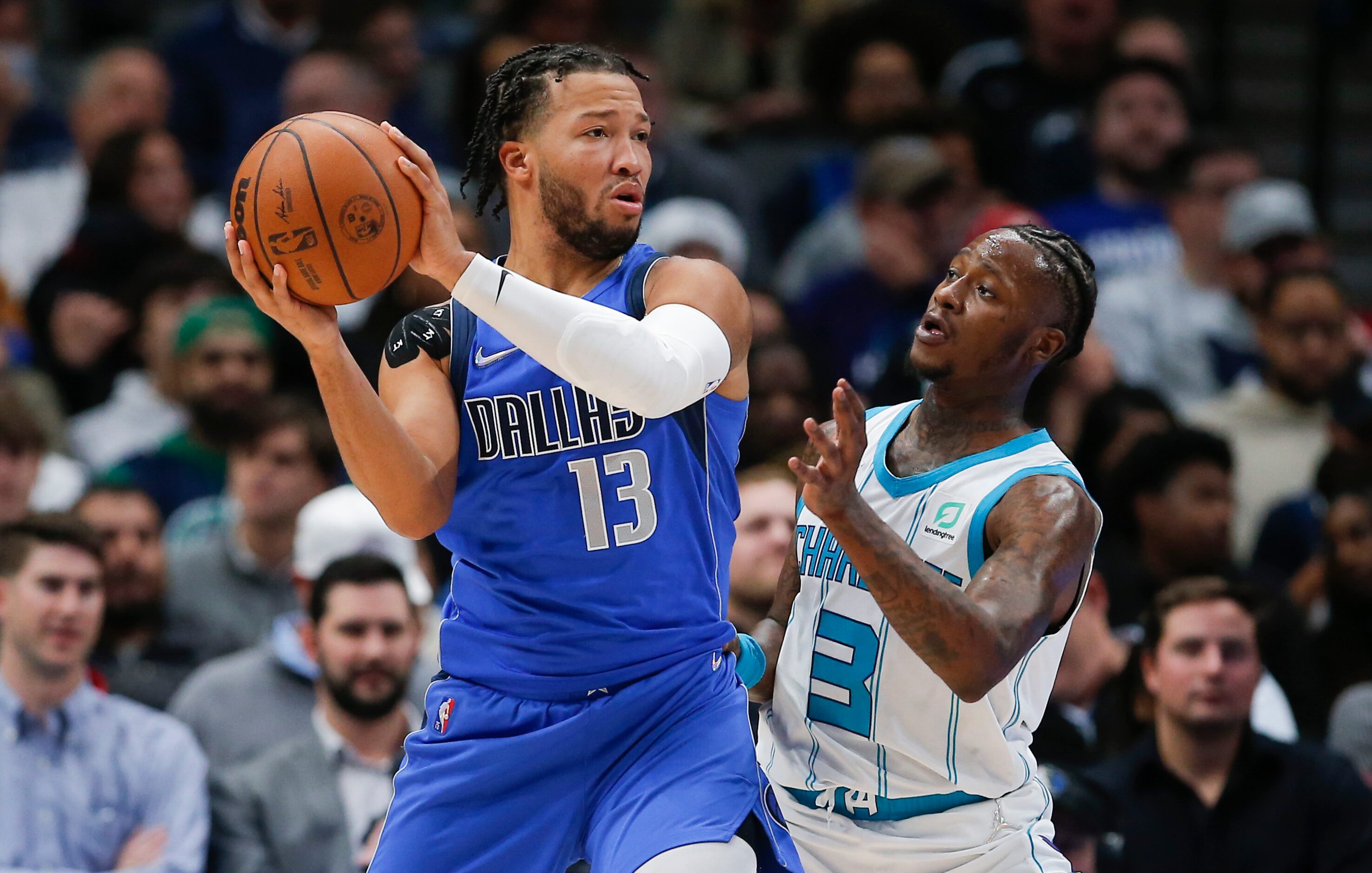 Dallas Mavericks guard Jalen Brunson (13) looks to pass as Charlotte Hornets guard Terry...