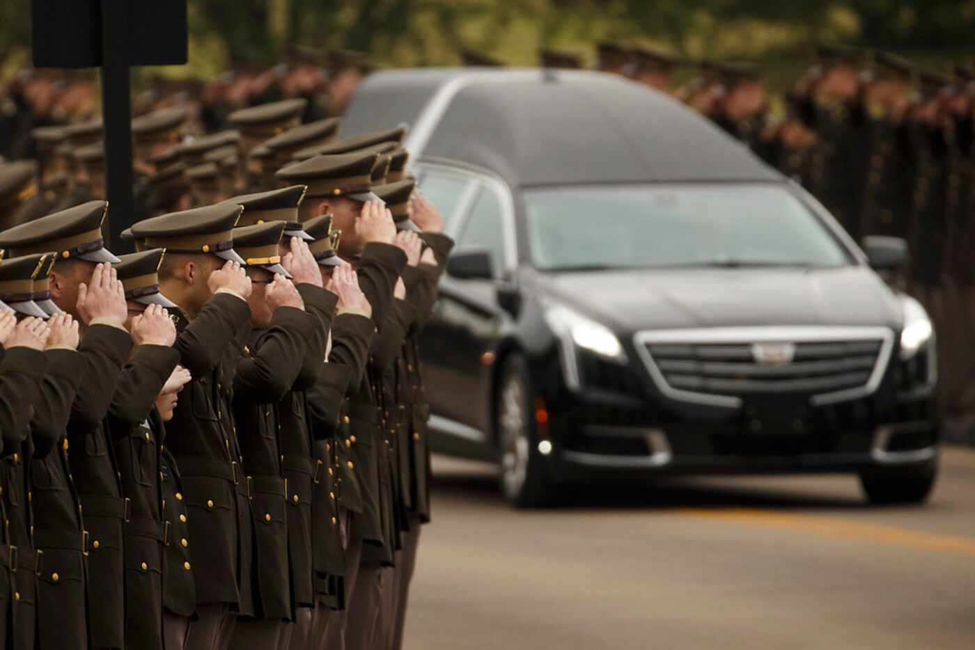 The hearse carrying former first lady Barbara Bush passes through members of the Texas A&M...