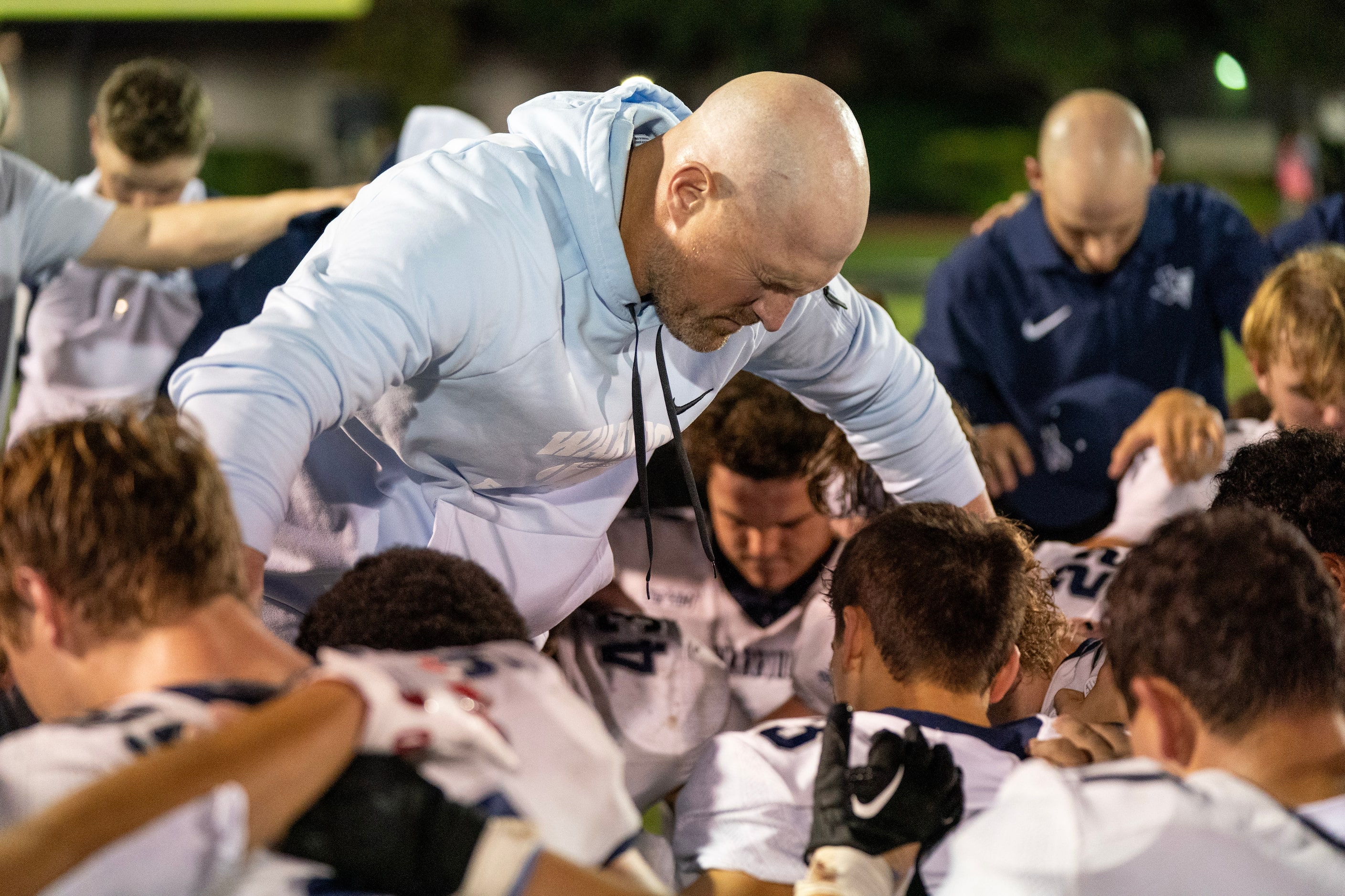 Former Dallas Cowboys great and Argyle Liberty Christian head coach Jason Witten prays with...