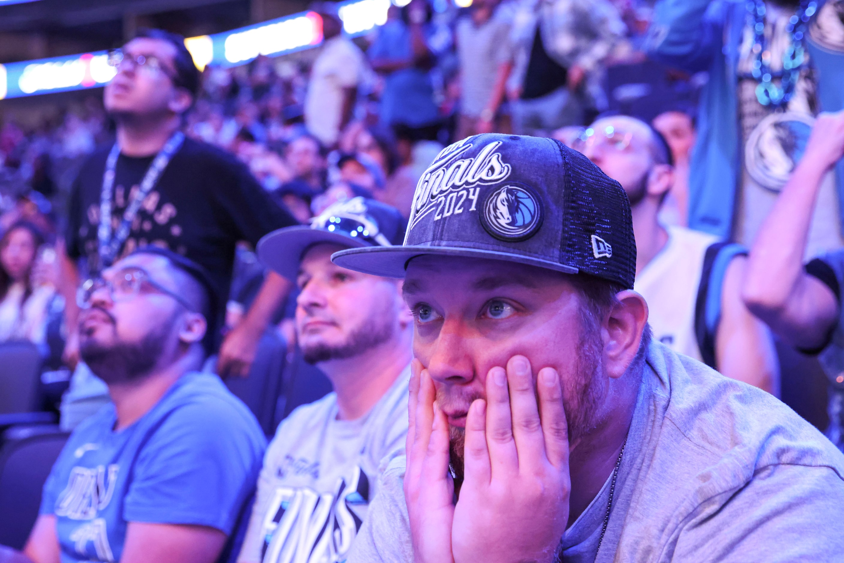 Jason Hicks (right), looks dejected during a watch party after Dallas Mavericks falls short...