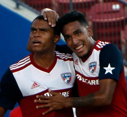 FC Dallas defenseman Reggie Cannon (2), left, is congratulated by teammate Jesus Ferreira...