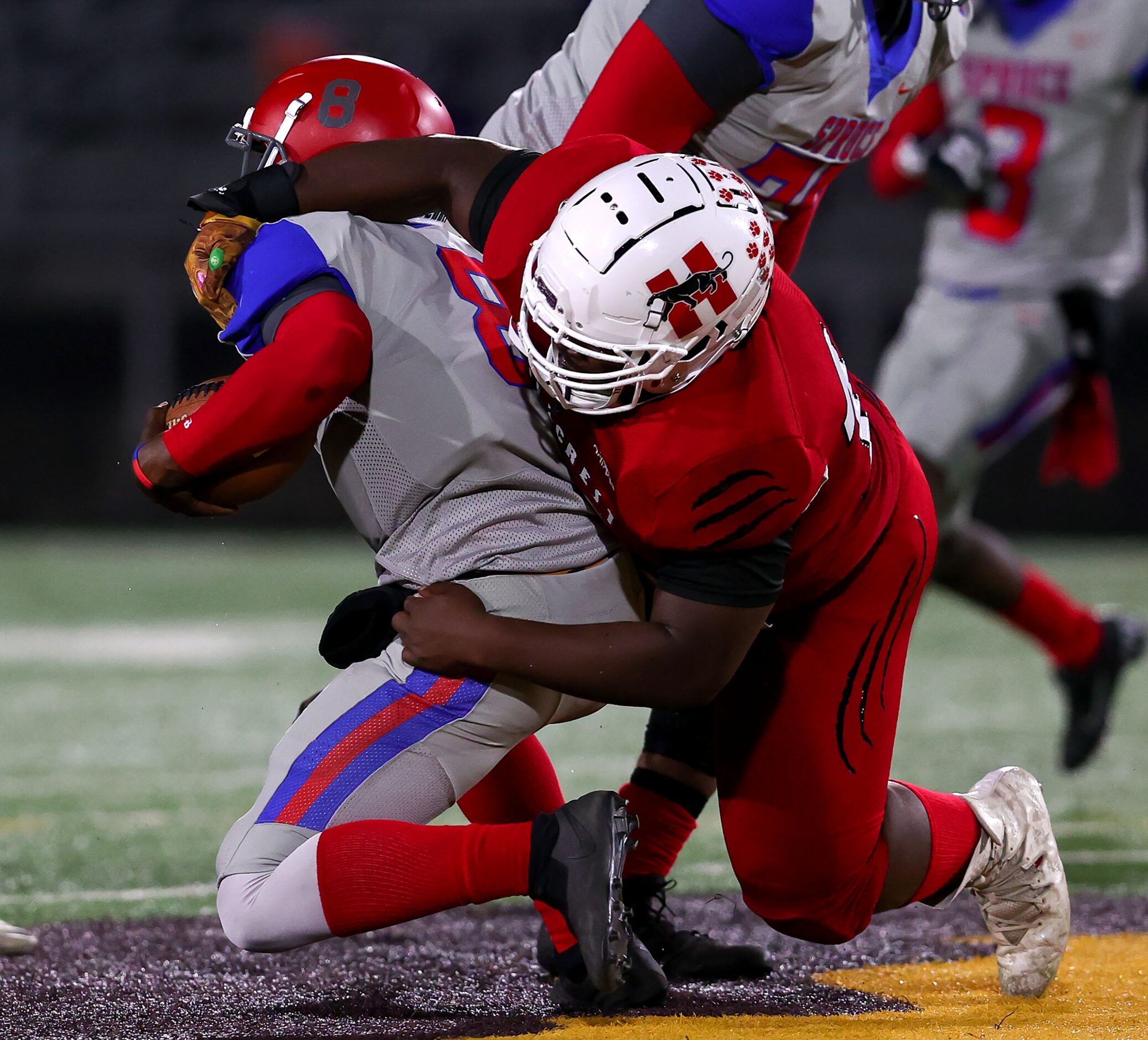 Hillcrest defensive lineman Clarence Sanders (R) gets a sack on Spruce quarterback Kelvin...