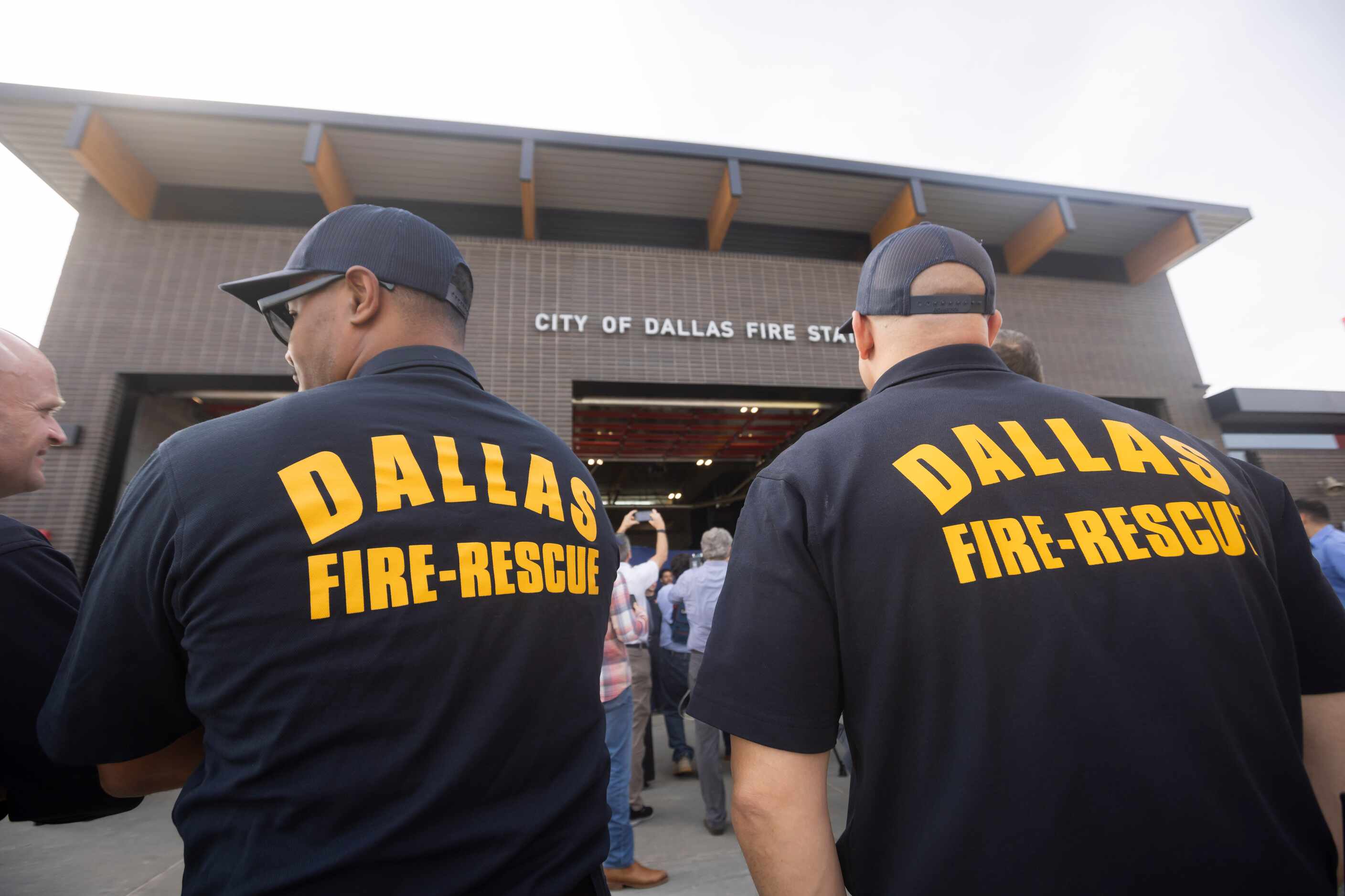 Members of Dallas Fire-Rescue stand outside of the new Dallas Fire Station No. 41 following...