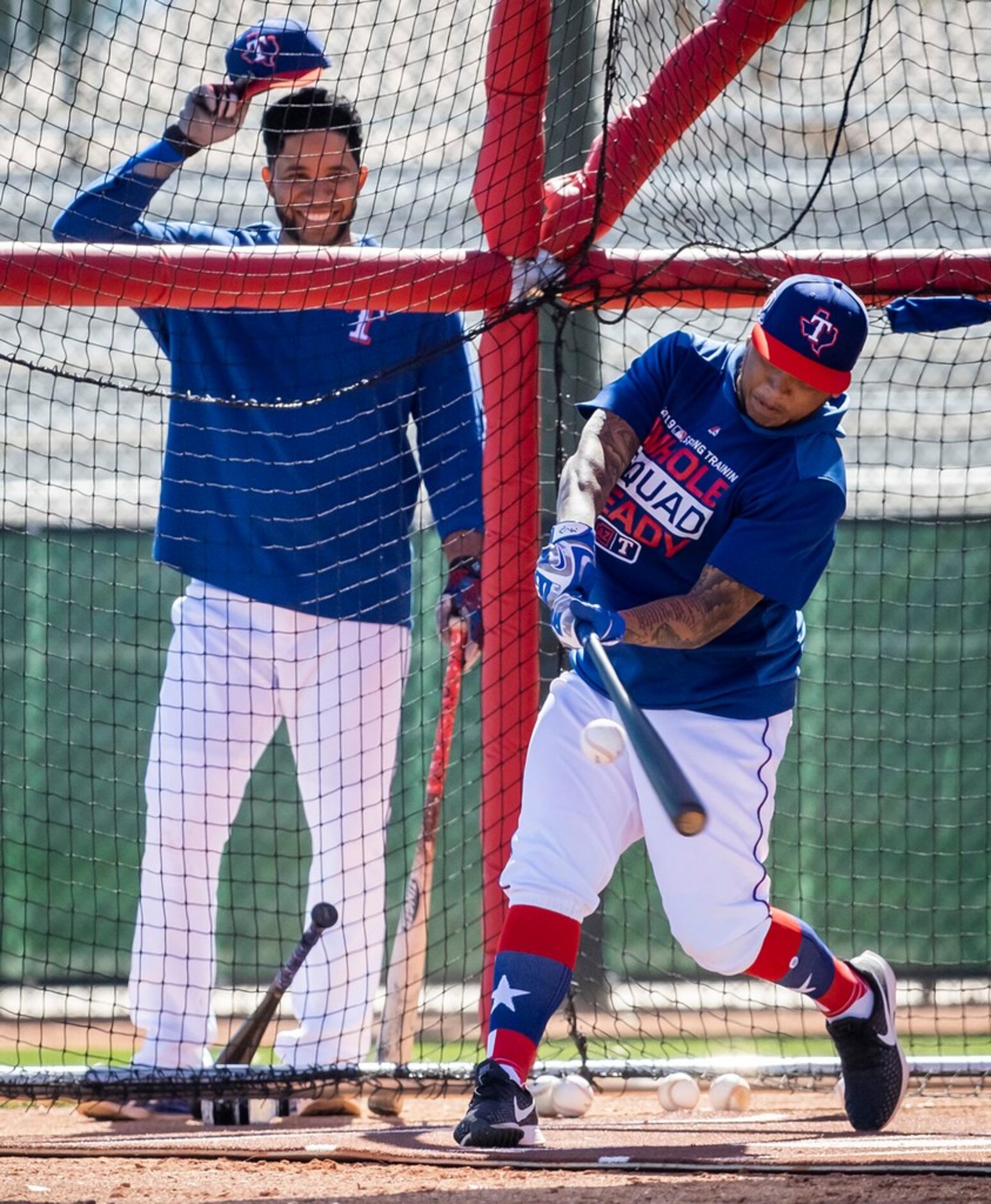 Texas Rangers outfielder Willie Calhoun takes batting practices as shortstop Elvis Andrus...