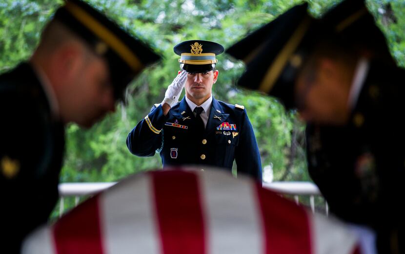 Members of the Army Honor Guard carry a casket containing the remains of Army Corporal...