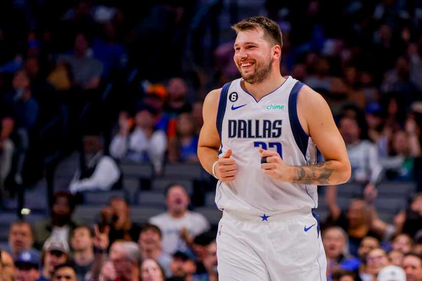 Dallas Mavericks point guard Luka Doncic smiles after making a basket during the first half...