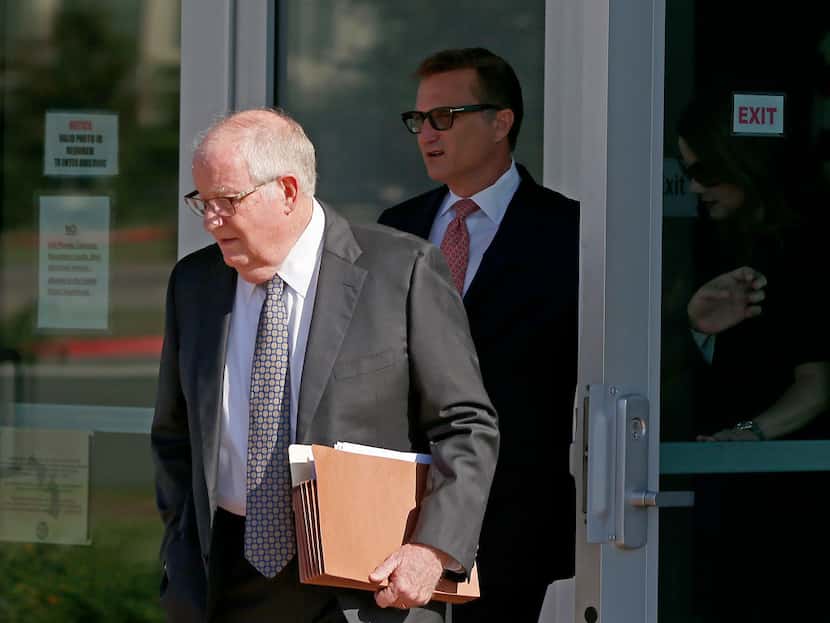 Kevin Bollman (background) leaves the courthouse behind his attorney, Michael Gibson, after...