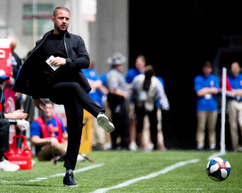 FC Cincinnati head coach Yoann Damet kicks a ball onto the field during an MLS soccer match...