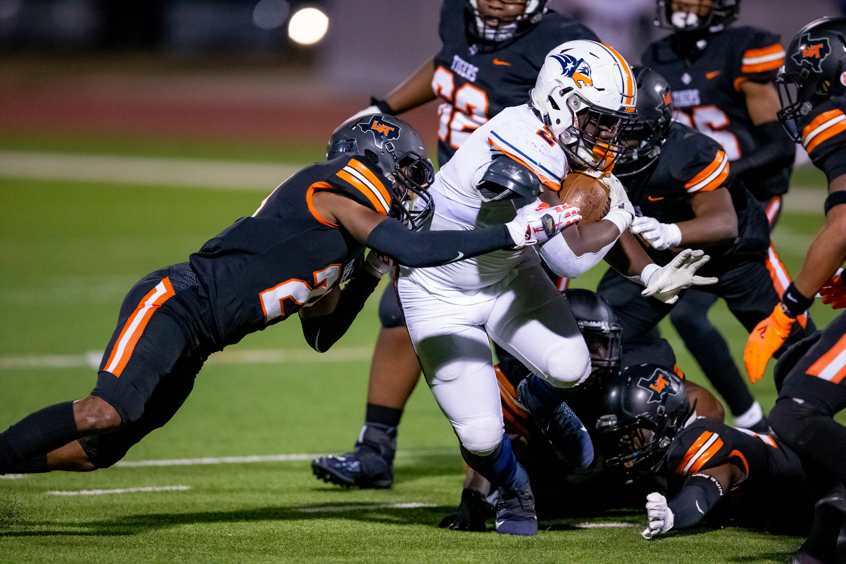 Wakeland junior running back Jared White (2) is tackled by Lancaster senior defensive back...