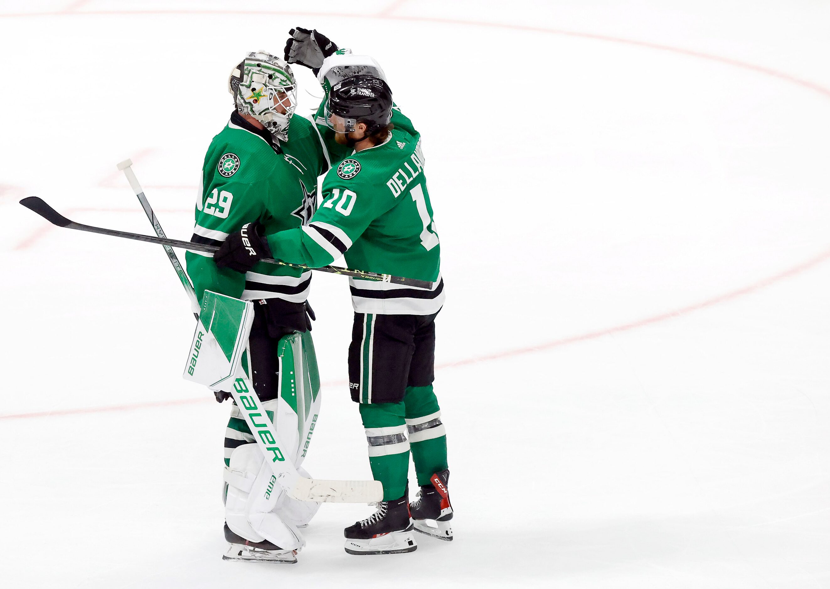 Dallas Stars center Ty Dellandrea (10) hugs goaltender Jake Oettinger (29) following their...