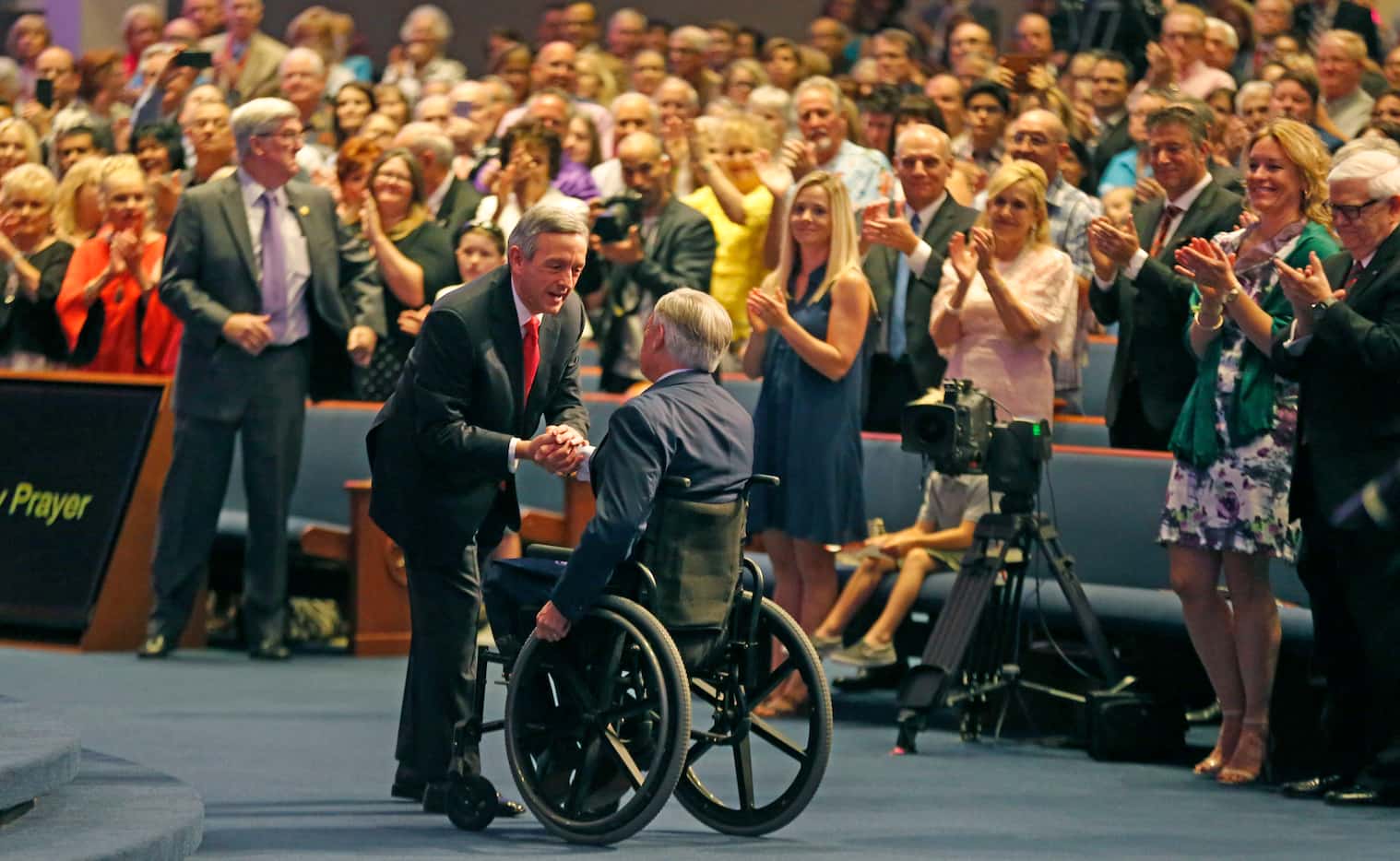 First Baptist Dallas pastor Dr. Robert Jeffress greets Texas Governor Greg Abbott during the...
