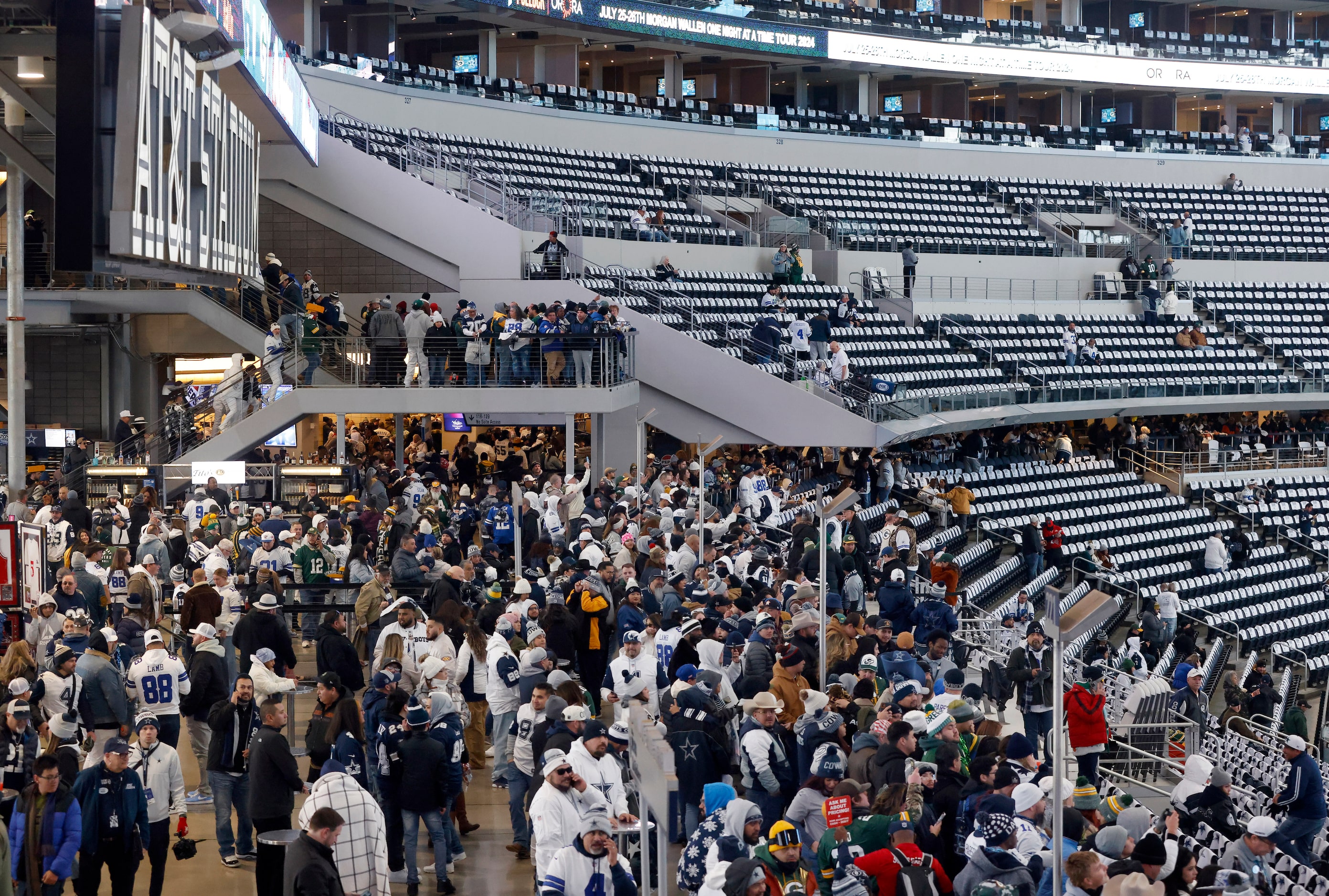 Dallas Cowboys and Green Bay Packers fans fill the west plaza after doors opened for the...